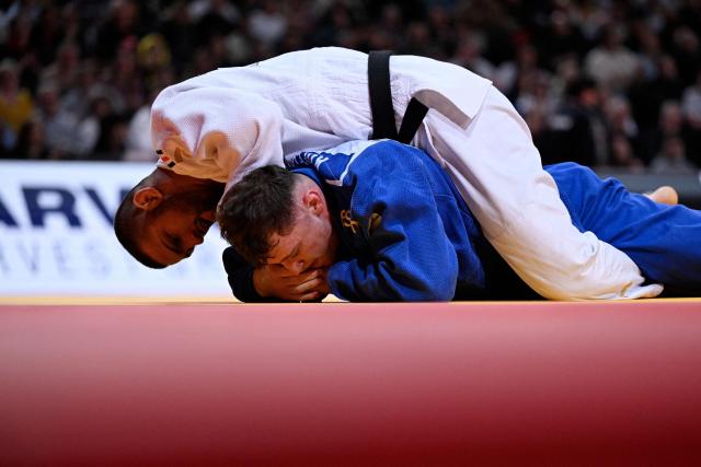 France's Alexis Mathieu (top) competes against Czech Adam Kopecky during their men's -90kg play-off match at the Paris Grand Slam judo tournament in Paris on February 8, 2026. (Photo by Julie SEBADELHA / AFP)