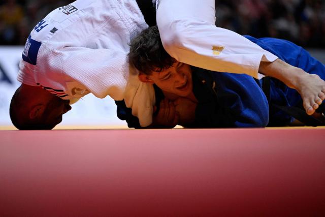 France's Alexis Mathieu (top) competes against Czech Adam Kopecky during their men's -90kg play-off match at the Paris Grand Slam judo tournament in Paris on February 8, 2026. (Photo by Julie SEBADELHA / AFP)