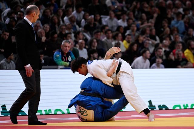Japan's Goki Tajima competes against Brazil's Guilherme Schimidt during their men's -90kg semi-final at the Paris Grand Slam judo tournament in Paris on February 8, 2026. (Photo by Julie SEBADELHA / AFP)