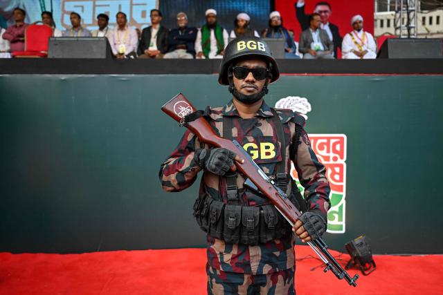 A Bangladesh Border Guard (BGB) personnel stands guard during an election rally of the Bangladesh Nationalist Party (BNP) ahead of the country's general election in Dhaka on February 8, 2026. Bangladesh's elections next week could reshape South Asia's balance of power, as Beijing seeks to consolidate influence and ties with India falter, analysts say. (Photo by Sajjad HUSSAIN / AFP)