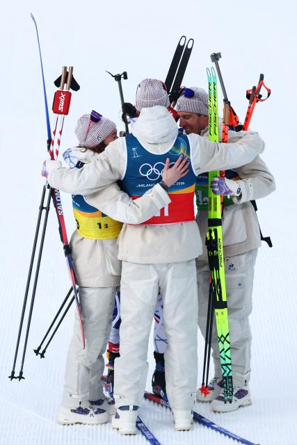 France's Lou Jeanmonnot, France's Julia Simon, 01-20 and France's Eric Perrot celebrate winning gold in the mixed biathlon 4 x 6km relay event during the Milano Cortina 2026 Winter Olympic Games at the Anterselva Biathlon Arena (Sudtirol Arena) in Anterselva (Val Pusteria) on February 8, 2026. (Photo by FRANCK FIFE / AFP)