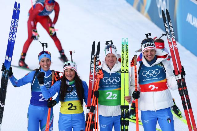 (From L to R): Italy's Lisa Vittozzi, Italy's Dorothea Wierer, Italy's Lukas Hofer and Italy's Tommaso Giacomel pose for a photograph after winning silver in the mixed biathlon 4 x 6km relay event during the Milano Cortina 2026 Winter Olympic Games at the Anterselva Biathlon Arena (Sudtirol Arena) in Anterselva (Val Pusteria) on February 8, 2026. (Photo by FRANCK FIFE / AFP)