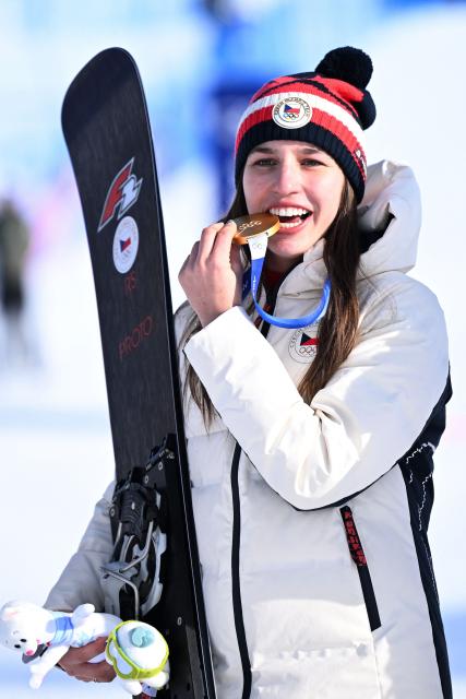 (From L) Gold medallist Czech Republic's Zuzana Maderova celebrates on the podium after the snowboard women's parallel giant slalom final at Livigno Snow Park during the Milano Cortina 2026 Winter Olympic Games, in Livigno (Valtellina), on February 8, 2026. (Photo by Kirill KUDRYAVTSEV / AFP)