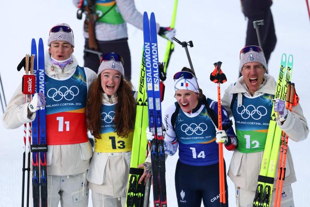 (From L to R): France's Eric Perrot, France's Lou Jeanmonnot, France's Julia Simon and France's Quentin Fillon Maillet pose for a photograph after winning gold in the mixed biathlon 4 x 6km relay event during the Milano Cortina 2026 Winter Olympic Games at the Anterselva Biathlon Arena (Sudtirol Arena) in Anterselva (Val Pusteria) on February 8, 2026. (Photo by FRANCK FIFE / AFP)