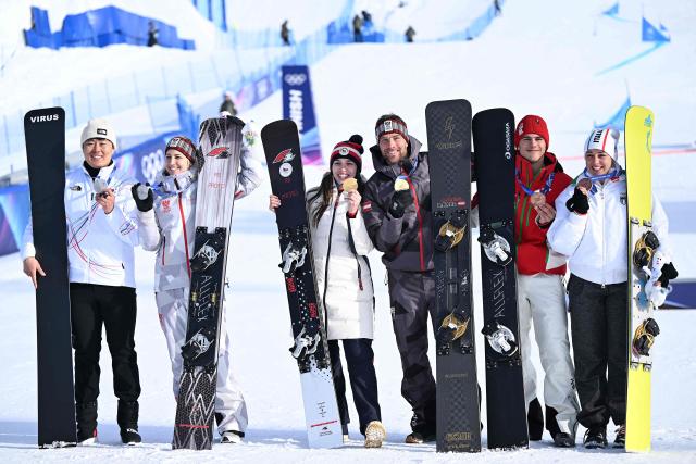 (From L) Silver medallists South Korea's Kim Sangkyum and Austria's Sabine Payer, gold medallists Czech Republic's Zuzana Maderova and Austria's Benjamin Karl, bronze medallists  Bulgaria's Tervel Zamfirov and Italy's Lucia Dalmasso pose with their medals after the snowboard men's and women's parallel giant slalom final at Livigno Snow Park during the Milano Cortina 2026 Winter Olympic Games, in Livigno (Valtellina), on February 8, 2026. (Photo by Kirill KUDRYAVTSEV / AFP)