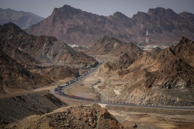 The pack rides during the 2nd stage of the Tour of Oman cycling race from Al Rustaq Fort to Yitti Hills on February 8, 2026. (Photo by Loic VENANCE / AFP)