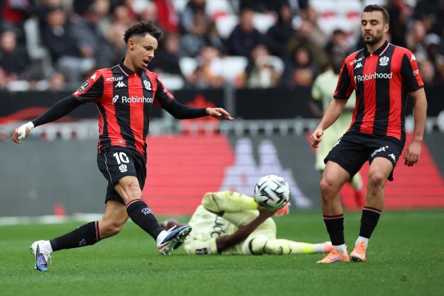 Monaco's Senegalese midfielder #15 Lamine Camara (C) fights for the ball with Nice's Moroccan forward #10 Sofiane Diop (L) during the French L1 football match between OGC Nice and AS Monaco at the Allianz Riviera Stadium in Nice, south-eastern France, on February 8, 2026.  (Photo by Valery HACHE / AFP)