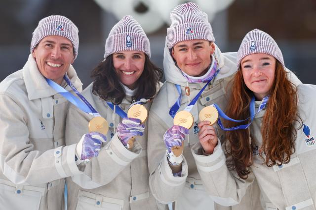 Gold medallists France's Eric Perrot, France's Quentin Fillon Maillet, France's Lou Jeanmonnot, France's Julia Simon pose with their medals on the podium of the mixed biathlon 4 x 6km relay event during the Milano Cortina 2026 Winter Olympic Games at the Anterselva Biathlon Arena (Sudtirol Arena) in Anterselva (Val Pusteria) on February 8, 2026. (Photo by FRANCK FIFE / AFP)
