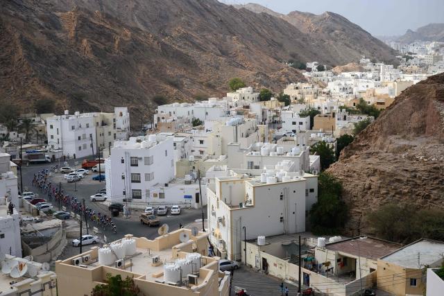 The pack rides during the 2nd stage of the Tour of Oman cycling race from Al Rustaq Fort to Yitti Hills on February 8, 2026. (Photo by Loic VENANCE / AFP)