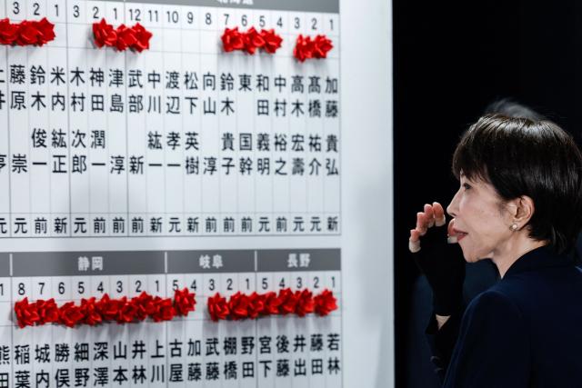 TOPSHOT - Japan's Prime Minister and President of the Liberal Democratic Party (LDP), Sanae Takaichi, gestures after speaking with media on the House of Representatives election day at the LDP headquarters in Tokyo on February 8, 2026. (Photo by Kim Kyung-Hoon / POOL / AFP)