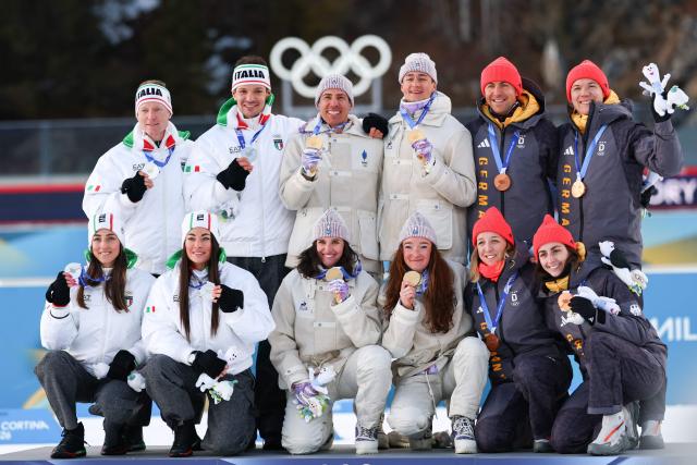 Silver medallists Italy's Tommaso Giacomel, Italy's Lukas Hofer, Italy's Dorothea Wierer and Italy's Lisa Vittozzi, gold medallists France's Eric Perrot, France's Quentin Fillon Maillet, France's Lou Jeanmonnot, France's Julia Simon and bronze medallists Germany's Justus Strelow, Germany's Philipp Nawrath, Germany's Vanessa Voigt, Germany's Franziska Preuss, pose on the podium of the mixed biathlon 4 x 6km relay event during the Milano Cortina 2026 Winter Olympic Games at the Anterselva Biathlon Arena (Sudtirol Arena) in Anterselva (Val Pusteria) on February 8, 2026. (Photo by FRANCK FIFE / AFP)