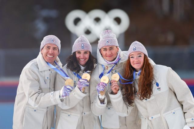 Gold medallists France's Eric Perrot, France's Quentin Fillon Maillet, France's Lou Jeanmonnot, France's Julia Simon pose with their medals on the podium of the mixed biathlon 4 x 6km relay event during the Milano Cortina 2026 Winter Olympic Games at the Anterselva Biathlon Arena (Sudtirol Arena) in Anterselva (Val Pusteria) on February 8, 2026. (Photo by FRANCK FIFE / AFP)