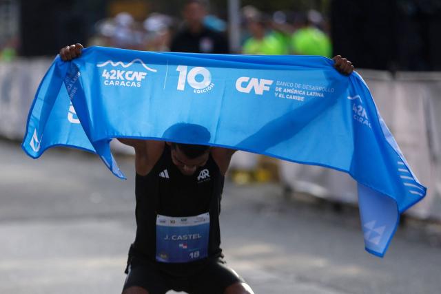 Panama's Jorge Castelblanco crosses the finish line to win the 42 km race during the 10th edition of the CAF Marathon in Caracas on February 8, 2026. (Photo by Pedro MATTEY / AFP)