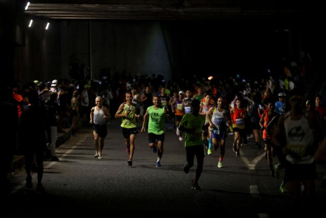 Runners take part in the 21 km and 42 km races of the 10th edition of the CAF Marathon in Caracas on February 8, 2026. (Photo by Pedro MATTEY / AFP)