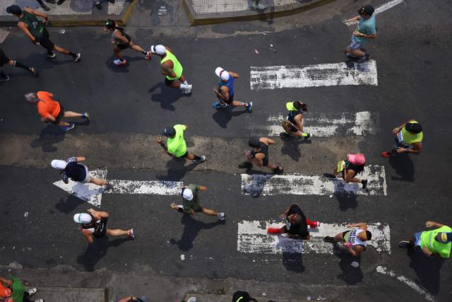 In this aerial view runners take part in the 21 km and 42 km races of the 10th edition of the CAF Marathon in Caracas on February 8, 2026. (Photo by Pedro MATTEY / AFP)