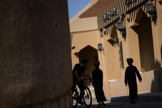Spectators arrive for the start of the 2nd stage of the Tour of Oman cycling race from Al Rustaq Fort to Yitti Hills, on February 8, 2026. (Photo by Loic VENANCE / AFP)