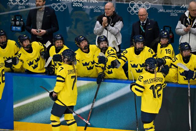 Sweden's players celebrate the opening goal by Sweden's #23 Thea Johansson during the women's preliminary round Group B Ice Hockey match between France and Sweden at the Milano Rho Ice Hockey Arena at the Milano Cortina 2026 Winter Olympic Games in Milan, on February 8, 2026. (Photo by Alexander NEMENOV / AFP)