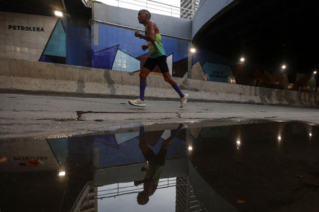 A runner takes part in the 21 km and 42 km races of the 10th edition of the CAF Marathon in Caracas on February 8, 2026. (Photo by Pedro MATTEY / AFP)