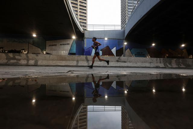 A runner takes part in the 21 km and 42 km races of the 10th edition of the CAF Marathon in Caracas on February 8, 2026. (Photo by Pedro MATTEY / AFP)