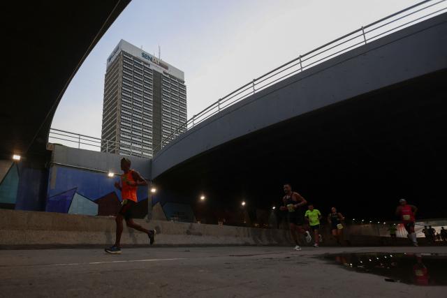 Runners take part in the 21 km and 42 km races of the 10th edition of the CAF Marathon in Caracas on February 8, 2026. (Photo by Pedro MATTEY / AFP)