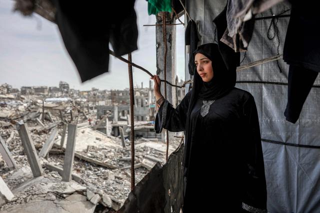 Etedal Rayyan (29), who recently returned back to Gaza from Egypt through the Rafah border crossing, looks out the window of her heavily-damaged house in the Jabalia camp for Palestinian refugees in the northern Gaza Strip on February 8, 2026. Rayyan was shot twice in her right leg in January 2024, after which she was evacuated to Egypt for treatment with her family, and finally returned over a year later after the Rafah border crossing reopened. (Photo by Omar AL-QATTAA / AFP)