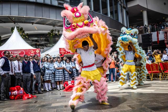 Students from the Confucius Institute take part in a lion dance performance during celebrations marking the Chinese Lunar New Year in Nairobi, on February 8, 2026, ahead of the upcoming Lunar New Year of the Horse. (Photo by Luis TATO / AFP)