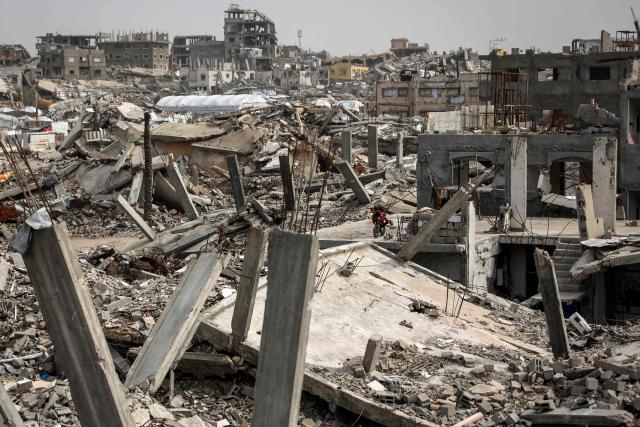 Destroyed buildings are pictured in the Jabalia camp for Palestinian refugees in the northern Gaza Strip on February 8, 2026. Since October 10, a fragile US-sponsored truce in Gaza has largely halted the fighting between Israeli forces and Hamas, but both sides have alleged frequent violations. (Photo by Omar AL-QATTAA / AFP)