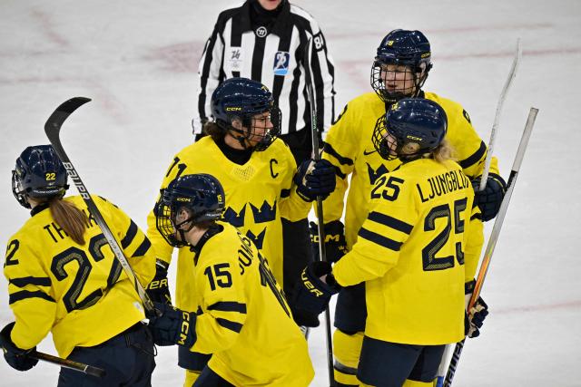 Sweden's players celebrate after Sweden's #22 Hanna Thuvik (L) scored the 3-0 goal during the women's preliminary round Group B Ice Hockey match between France and Sweden at the Milano Rho Ice Hockey Arena at the Milano Cortina 2026 Winter Olympic Games in Milan, on February 8, 2026. (Photo by Alexander NEMENOV / AFP)