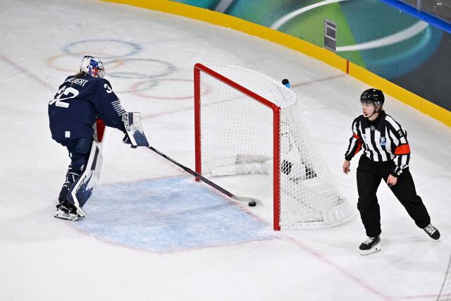 France's #32 Alice Philbert (L) reacts after Sweden's the 3-0 goal during the women's preliminary round Group B Ice Hockey match between France and Sweden at the Milano Rho Ice Hockey Arena at the Milano Cortina 2026 Winter Olympic Games in Milan, on February 8, 2026. (Photo by Alexander NEMENOV / AFP)