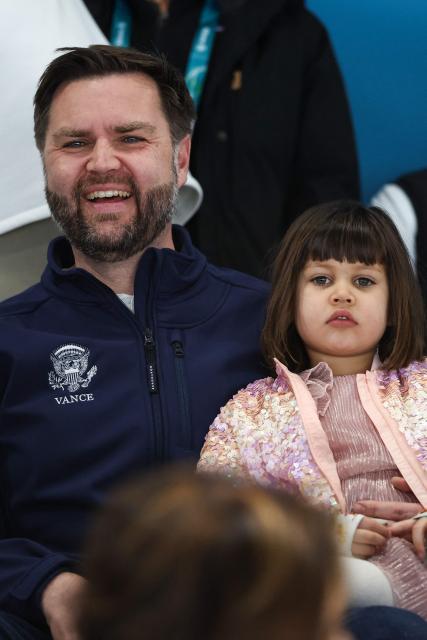 US Vice President JD Vance (L) holds his daughter Mirabel as they attend the speed skating men's 5000m during the Milano Cortina 2026 Winter Olympic Games at Milano Speed Skating Stadium in Milan on February 8, 2026. (Photo by Kevin Lamarque / AFP)