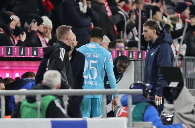 Hoffenheim's German defender #25 Kevin Akpoguma leaves the pitch after being shown a red card during the German first division Bundesliga football match between FC Bayern Munich and TSG 1899 Hoffenheim in Munich, southern Germany on February 8, 2026. (Photo by Alexandra BEIER / AFP) / DFL REGULATIONS PROHIBIT ANY USE OF PHOTOGRAPHS AS IMAGE SEQUENCES AND/OR QUASI-VIDEO