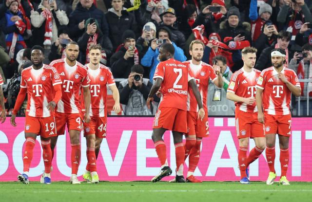 Bayern Munich's English forward #09 Harry Kane (3R) celebrates with teammates scoring his team's first goal during the German first division Bundesliga football match between FC Bayern Munich and TSG 1899 Hoffenheim in Munich, southern Germany on February 8, 2026. (Photo by Alexandra BEIER / AFP) / DFL REGULATIONS PROHIBIT ANY USE OF PHOTOGRAPHS AS IMAGE SEQUENCES AND/OR QUASI-VIDEO