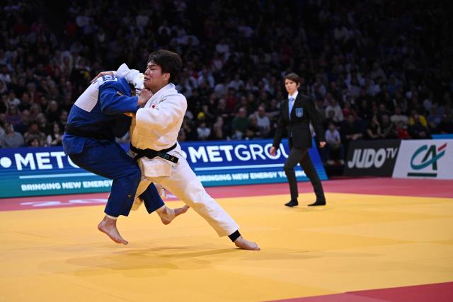 Japan's Goki Tajima (R) competes against Japan's Hidetoshi Tokumochi in the men's -90kg Final bout at the Paris Grand Slam judo tournament in Paris on February 8, 2026. (Photo by Julie SEBADELHA / AFP)