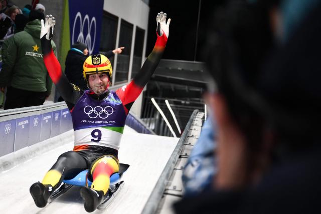 Germany's Timon Grancagnolo reacts in the finish area after competing in the luge men's singles run 4 at Cortina Sliding Centre during the Milano Cortina 2026 Winter Olympic Games in Cortina d'Ampezzo on February 8, 2026. (Photo by Marco BERTORELLO / AFP)