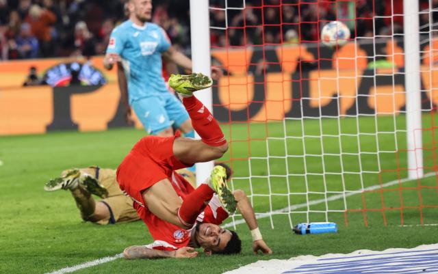Bayern Munich's Colombian forward #14 Luis Diaz falls after scoring the 4-1 during the German first division Bundesliga football match between FC Bayern Munich and TSG 1899 Hoffenheim in Munich, southern Germany on February 8, 2026. (Photo by Alexandra BEIER / AFP) / DFL REGULATIONS PROHIBIT ANY USE OF PHOTOGRAPHS AS IMAGE SEQUENCES AND/OR QUASI-VIDEO