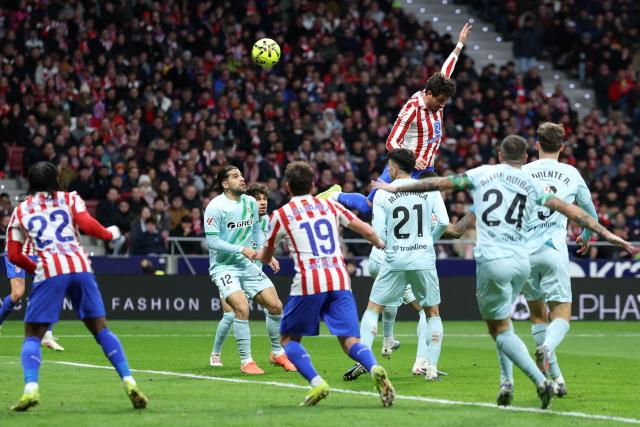 Atletico Madrid's Uruguayan defender #02 Jose Gimenez (up) heads the ball during the Spanish league football match between Club Atletico de Madrid and Real Betis at Metropolitano Stadium in Madrid on February 8, 2026. (Photo by Thomas COEX / AFP)