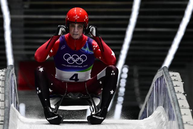Latvia's Gints Berzins reacts in the finish area after competing in the luge men's singles run 4 at Cortina Sliding Centre during the Milano Cortina 2026 Winter Olympic Games in Cortina d'Ampezzo on February 8, 2026. (Photo by Stefano RELLANDINI / AFP)