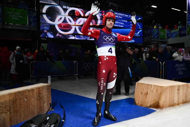 Latvia's Gints Berzins reacts in the finish area after competing in the luge men's singles run 4 at Cortina Sliding Centre during the Milano Cortina 2026 Winter Olympic Games in Cortina d'Ampezzo on February 8, 2026. (Photo by Marco BERTORELLO / AFP)