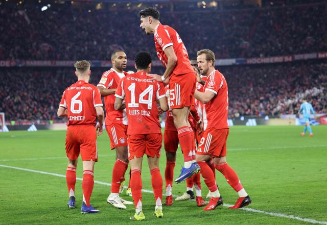Bayern Munich's Colombian forward #14 Luis Diaz celebrates with teammates scoring the 4-1 during the German first division Bundesliga football match between FC Bayern Munich and TSG 1899 Hoffenheim in Munich, southern Germany on February 8, 2026. (Photo by Alexandra BEIER / AFP) / DFL REGULATIONS PROHIBIT ANY USE OF PHOTOGRAPHS AS IMAGE SEQUENCES AND/OR QUASI-VIDEO