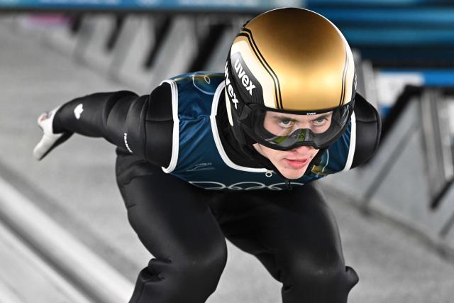 France's Jules Chervet goes down the inrun during the men's ski jumping normal hill training of the Milano Cortina 2026 Winter Olympic Games at Predazzo Ski Jumping Stadium in Predazzo (Val di Fiemme), on February 8, 2026. (Photo by Javier SORIANO / AFP)