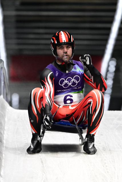 Austria's Nico Gleirscher reacts in the finish area after competing in the luge men's singles run 4 at Cortina Sliding Centre during the Milano Cortina 2026 Winter Olympic Games in Cortina d'Ampezzo on February 8, 2026. (Photo by Stefano RELLANDINI / AFP)