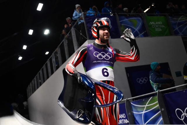 Austria's Nico Gleirscher reacts in the finish area after competing in the luge men's singles run 4 at Cortina Sliding Centre during the Milano Cortina 2026 Winter Olympic Games in Cortina d'Ampezzo on February 8, 2026. (Photo by Marco BERTORELLO / AFP)