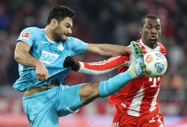 TOPSHOT - Hoffenheim's Turkish defender #05 Ozan Kabak (L) and Bayern Munich's Senegalese forward #11 Nicolas Jackson vie for the ball during the German first division Bundesliga football match between FC Bayern Munich and TSG 1899 Hoffenheim in Munich, southern Germany on February 8, 2026. (Photo by Alexandra BEIER / AFP) / DFL REGULATIONS PROHIBIT ANY USE OF PHOTOGRAPHS AS IMAGE SEQUENCES AND/OR QUASI-VIDEO