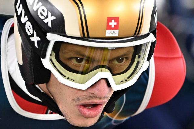 Switzerland's Gregor Deschwanden prepares for a jump during the men's ski jumping normal hill training of the Milano Cortina 2026 Winter Olympic Games at Predazzo Ski Jumping Stadium in Predazzo (Val di Fiemme), on February 8, 2026. (Photo by Javier SORIANO / AFP)
