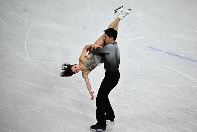 Japan's Riku Miura (L) and Japan's Ryuichi Kihara (R) compete in the figure skating pair free skating team event during the Milano Cortina 2026 Winter Olympic Games at Milano Ice Skating Arena in Milan on February 8, 2026. (Photo by JULIEN DE ROSA / AFP)