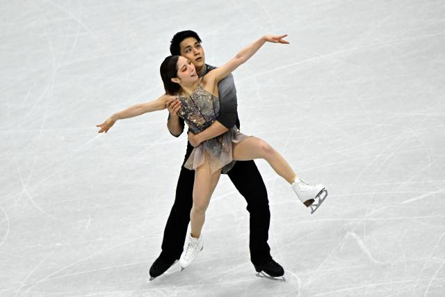 Japan's Riku Miura (L) and Japan's Ryuichi Kihara (R) compete in the figure skating pair free skating team event during the Milano Cortina 2026 Winter Olympic Games at Milano Ice Skating Arena in Milan on February 8, 2026. (Photo by JULIEN DE ROSA / AFP)