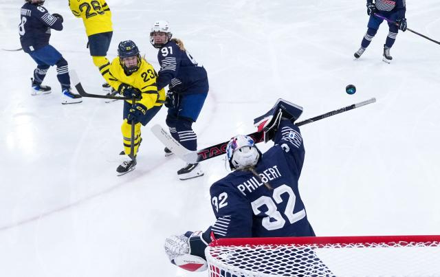 France's #32 Alice Philbert blocks the puck during the women's preliminary round Group B Ice Hockey match between France and Sweden at the Milano Rho Ice Hockey Arena at the Milano Cortina 2026 Winter Olympic Games in Milan, on February 8, 2026. (Photo by Tao Xiyi / POOL / AFP)