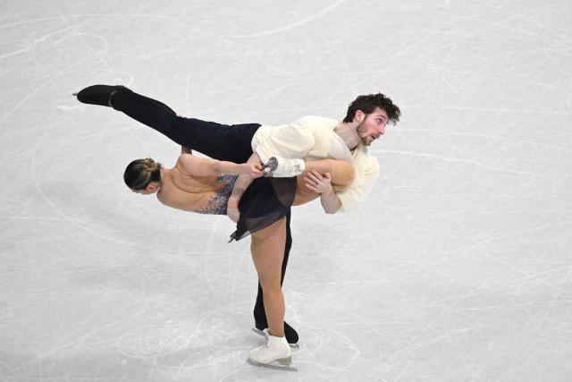 Italy's Sara Conti (L) and Italy's Niccolo Macii (R) compete in the figure skating pair free skating team event during the Milano Cortina 2026 Winter Olympic Games at Milano Ice Skating Arena in Milan on February 8, 2026. (Photo by Antonin THUILLIER / AFP)