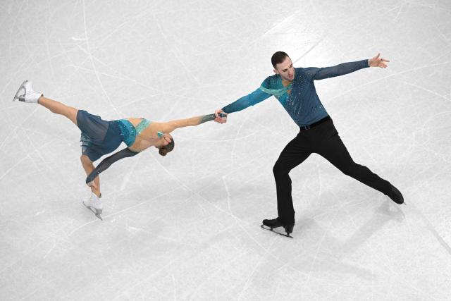 Georgia's Anastasiia Metelkina (L) and Georgia's Luka Berulava (R) compete in the figure skating pair free skating team event during the Milano Cortina 2026 Winter Olympic Games at Milano Ice Skating Arena in Milan on February 8, 2026. (Photo by Antonin THUILLIER / AFP)