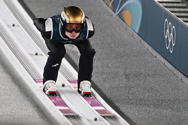 Norway's Marius Lindvik goes down the inrun during the men's ski jumping normal hill training of the Milano Cortina 2026 Winter Olympic Games at Predazzo Ski Jumping Stadium in Predazzo (Val di Fiemme), on February 8, 2026. (Photo by Javier SORIANO / AFP)